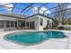 Aerial view of a backyard featuring a swimming pool, patio, and a well-manicured lawn at 1559 Wescott Loop, Winter Springs, FL 32708