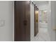 Modern bathroom featuring a stylish sliding door and marble floors that lead to a luxurious soaking tub at 1559 Wescott Loop, Winter Springs, FL 32708