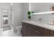 Elegant bathroom featuring a modern vanity with a backlit mirror and a glass-enclosed shower with access to the backyard at 1559 Wescott Loop, Winter Springs, FL 32708