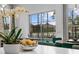 Dining area showcasing a sunlit view of the pool and backyard through large windows at 1559 Wescott Loop, Winter Springs, FL 32708