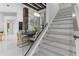 Open-concept dining room featuring modern furniture, glass staircase, and marble flooring at 1559 Wescott Loop, Winter Springs, FL 32708