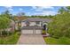 Stunning two-story home showcasing a brick driveway and a manicured lawn at 1559 Wescott Loop, Winter Springs, FL 32708
