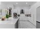 Modern kitchen with white cabinetry, quartz countertops, stainless steel appliances, and a kitchen island at 1559 Wescott Loop, Winter Springs, FL 32708
