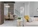 Open-concept room features sleek modern furniture, and a clear staircase offering a bright airy design at 1559 Wescott Loop, Winter Springs, FL 32708