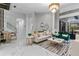 Elegant living room with marble floors, contemporary furniture, and ample natural light at 1559 Wescott Loop, Winter Springs, FL 32708