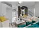 Open-concept living room featuring a decorative entryway and staircase with glass railings at 1559 Wescott Loop, Winter Springs, FL 32708