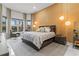 Luxurious main bedroom with bay window sitting area, pendant lighting, and textured wall design at 1559 Wescott Loop, Winter Springs, FL 32708