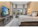 Beautiful bedroom with a bay window sitting area, and a wall-mounted TV, creating a cozy retreat at 1559 Wescott Loop, Winter Springs, FL 32708