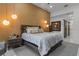 Stylish main bedroom with textured wall, modern lighting, and elegant furnishings and decor at 1559 Wescott Loop, Winter Springs, FL 32708
