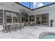 Covered patio with outdoor dining and seating, offering poolside views and relaxation space at 1559 Wescott Loop, Winter Springs, FL 32708
