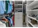 Organized walk-in closet featuring hanging clothes, folded items, and shoe shelves for optimal storage at 1559 Wescott Loop, Winter Springs, FL 32708