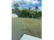 Backyard with a black metal fence, lush green grass and an abundance of trees and nature beyond at 1723 Post Oak Dr, Davenport, FL 33837