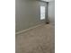 Neutral bedroom with tan carpet, blank walls, and natural light from a window at 1723 Post Oak Dr, Davenport, FL 33837
