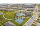 The aerial view shows a neighborhood including a pool, tennis court, bocce ball court and clubhouse at 2019 Spring Shower Cir, Kissimmee, FL 34744