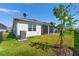 The exterior of the house showing the backyard, patio, and well-maintained lawn at 2019 Spring Shower Cir, Kissimmee, FL 34744