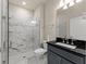 Bathroom featuring a glass-enclosed shower and dark vanity at 2019 Spring Shower Cir, Kissimmee, FL 34744