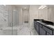 Elegant bathroom with marble walk-in shower and a double sink vanity at 2019 Spring Shower Cir, Kissimmee, FL 34744