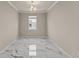 Bright, empty room with modern marble floors and a large window at 2019 Spring Shower Cir, Kissimmee, FL 34744