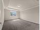 Spacious bedroom with tray ceiling, neutral tones and a large window at 2019 Spring Shower Cir, Kissimmee, FL 34744