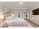 Inviting bedroom with luxurious bedding, tray ceiling and stylish furniture at 2019 Spring Shower Cir, Kissimmee, FL 34744