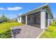 The exterior of the home featuring a covered patio and green lawn with black fencing at 2019 Spring Shower Cir, Kissimmee, FL 34744