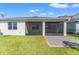 Exterior of the home showcasing the covered patio and well-maintained lawn at 2019 Spring Shower Cir, Kissimmee, FL 34744