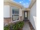 Stylish front door with stone accents and lush landscaping at 2019 Spring Shower Cir, Kissimmee, FL 34744
