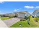 Exterior of a one-story home featuring a paver driveway and landscaped front yard at 2019 Spring Shower Cir, Kissimmee, FL 34744