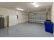 Spacious garage with epoxy flooring, white brick walls, and ample storage space at 2019 Spring Shower Cir, Kissimmee, FL 34744
