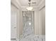 Hallway with an ornate light fixture and views to connecting rooms at 2019 Spring Shower Cir, Kissimmee, FL 34744