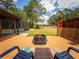 Backyard featuring a patio with a fire pit, seating area, and a view of the pool area at 20249 Macon Pkwy, Orlando, FL 32833