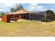Backyard with a screened-in pool area, patio with a fire pit, and a privacy fence, perfect for outdoor living at 20249 Macon Pkwy, Orlando, FL 32833