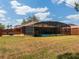 Expansive backyard featuring a screened pool, cozy fire pit area, and lush green lawn at 20249 Macon Pkwy, Orlando, FL 32833