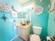 Coastal-inspired bathroom featuring a stylish glass vessel sink, nautical decor, and a bright blue color scheme at 20249 Macon Pkwy, Orlando, FL 32833