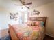 Inviting bedroom showcases a wooden bed frame, ceiling fan, and a window for natural light at 20249 Macon Pkwy, Orlando, FL 32833