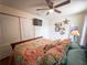 Comfortable bedroom with wooden bed, ceiling fan, mounted television, and convenient closet space at 20249 Macon Pkwy, Orlando, FL 32833