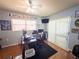 This bedroom features a ceiling fan, work desk, and a glass sliding door at 20249 Macon Pkwy, Orlando, FL 32833
