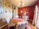 Red-toned dining room features chandelier, decor, table, seating for four, and large window at 20249 Macon Pkwy, Orlando, FL 32833