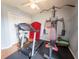 Well-equipped home gym features a treadmill, weight machine, and dedicated workout space at 20249 Macon Pkwy, Orlando, FL 32833