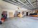 Large garage featuring epoxy floor, lots of storage space and door to the backyard for convenience at 20249 Macon Pkwy, Orlando, FL 32833