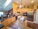 Bright kitchen features stainless appliances, granite counters, central island, and lots of farmhouse-themed decor at 20249 Macon Pkwy, Orlando, FL 32833