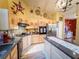 Well-lit kitchen featuring a gas stovetop, stainless steel fridge, and farmhouse-style decor at 20249 Macon Pkwy, Orlando, FL 32833