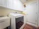 Well-lit laundry room with a sink, washer and dryer, and ample storage space at 20249 Macon Pkwy, Orlando, FL 32833