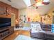 Comfortable living room with fan, vaulted ceilings, decor, and a view to the kitchen area at 20249 Macon Pkwy, Orlando, FL 32833
