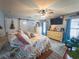 Inviting main bedroom featuring a ceiling fan, a dresser, and seaside-themed decor at 20249 Macon Pkwy, Orlando, FL 32833