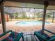 Relaxing screened-in pool with two lounge chairs and lush greenery at 20249 Macon Pkwy, Orlando, FL 32833