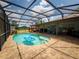 Screened-in pool with brick patio and view of the home's backyard at 20249 Macon Pkwy, Orlando, FL 32833