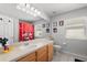 Bright bathroom with vanity, mirror, and Mickey Mouse themed decor at 206 Bonville Dr, Davenport, FL 33897