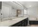 Bathroom featuring double sinks, a soaking tub, and a glass-enclosed shower at 206 Bonville Dr, Davenport, FL 33897
