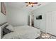 Bedroom with hardwood floors, ceiling fan, and closet access to laundry room at 206 Bonville Dr, Davenport, FL 33897